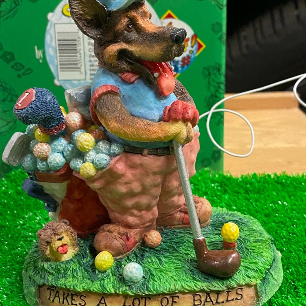Enesco New with box, dog playing golf statue.